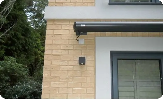 External security lighting and a camera mounted on the corner of a house