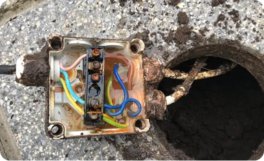 A corroded underground junction box opened up during fault finding